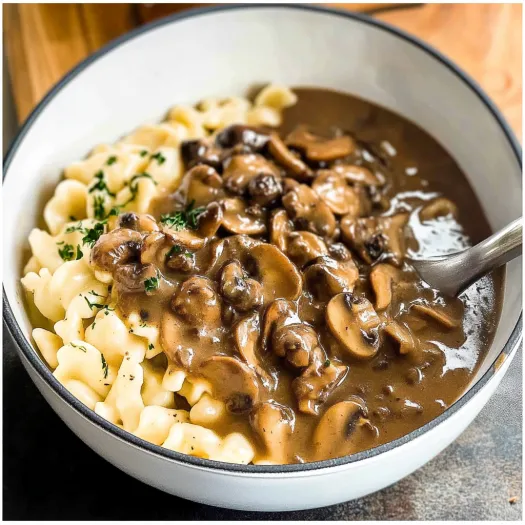 A bowl of Spaetzle with mushroom gravy.