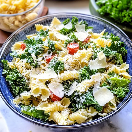 A bowl of pasta salad with kale and cheese.
