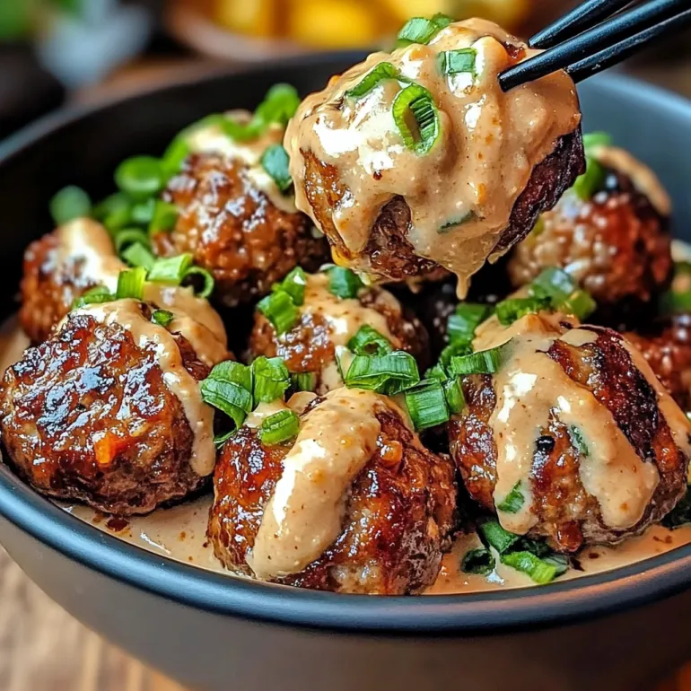 A bowl of meatballs with spicy mayo dip.